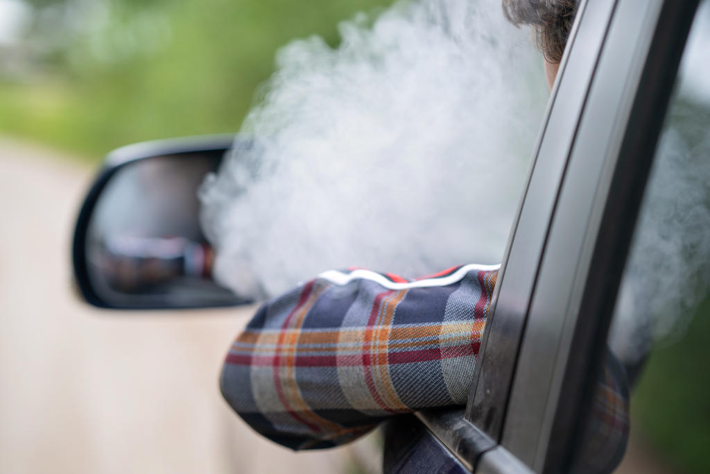 This image highlights the source of lingering interior odor. Cigarette smoke embeds itself into car upholstery, requiring smoke odor removal products and targeted cleaning. A good odor neutralizer spray is key to restoring a fresh driving environment.